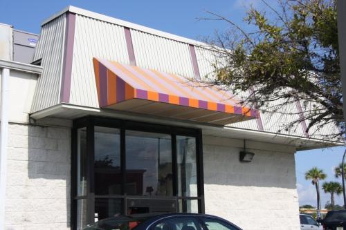 Building with colorful awning and windows