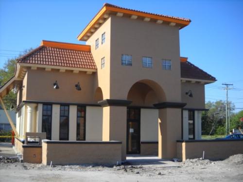 Small stucco building with tiled roof