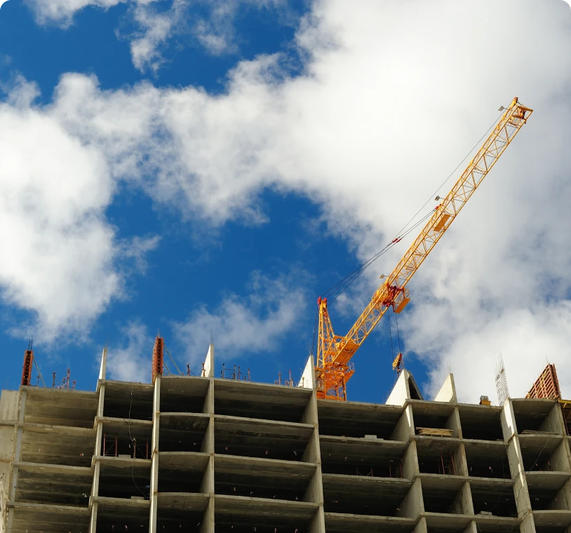 High-rise construction with crane and clouds